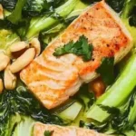 Salmon and Bok Choy Green Coconut Curry on a rustic table for cozy night meals.