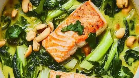 Salmon and Bok Choy Green Coconut Curry on a rustic table for cozy night meals.
