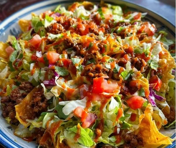 Taco Salad with Catalina Dressing topped with fresh ingredients in a bowl.