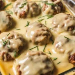 Amish Hamburger Steak Bake with creamy gravy and seasoned beef patties
