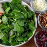 Fresh Winter Spinach Salad with seasonal toppings and dressing